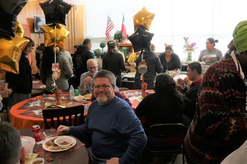 Sixth grade teachers and members of staff enjoying their Thanksgiving lunch 